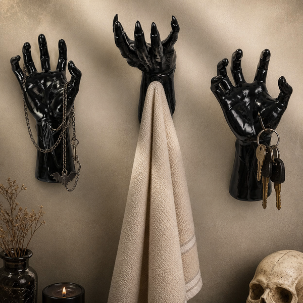 Creepy hand decor displayed on a shelf with skulls and candles
